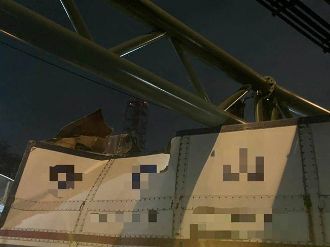 一部联结车29日误闯楠梓区国1下方的限高涵洞，导致货柜卡在防撞杆上。（翻摄照片／林瑞益高雄传真）