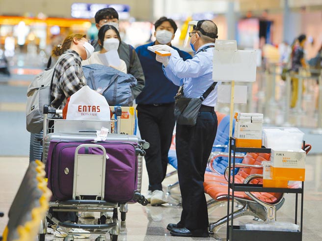 疫情指挥中心29日公布国内新增1例本土及10例境外移入，显示严守边境的重要性。图为境外生在入境大厅领取防疫人员发放的快筛试剂。（陈麒全摄）