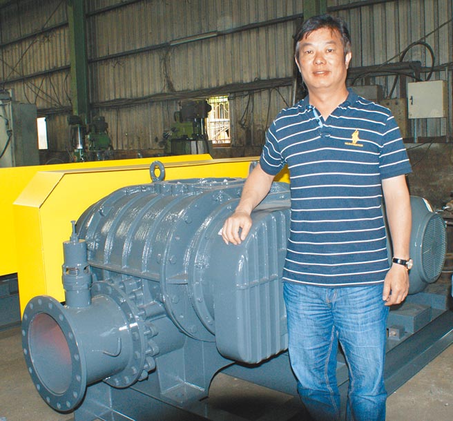 黑伟机械董事长林明赐，身旁为即将出货的EVG系列大型鼓风机。图／傅秉祥