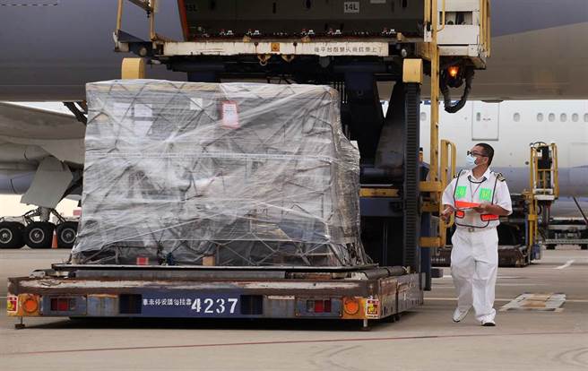 裝載疫苗的冷凍貨櫃卸下後，海關人員立即上前核對貨物清單。（范揚光攝）