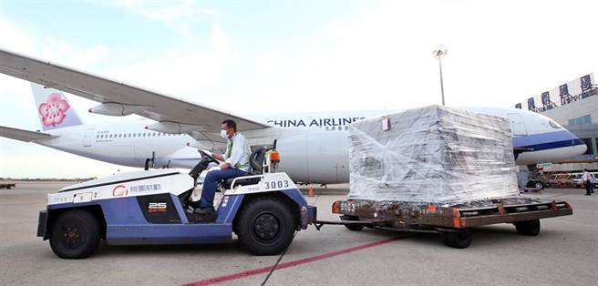 班機停妥後，地勤人員卸下裝載疫苗的冷凍貨櫃。（范揚光攝）