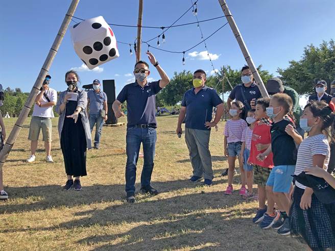 杨镇浯县长今天下午也来到现场，与小朋友一起玩掷骰子、拿奖品。（李金生摄）