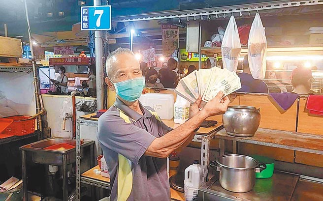 高雄凱旋青年夜市攤商受惠商圈夜市券，開心出示營業收取到的商圈夜市券。（高市經發局提供／柯宗緯高雄傳真）
