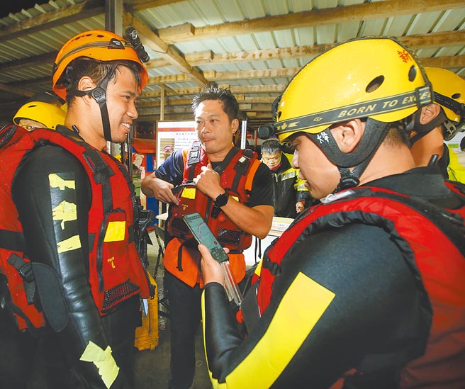 新北消防人員整裝聽取簡報，分批搶救落水失蹤民眾。（陳怡誠攝）