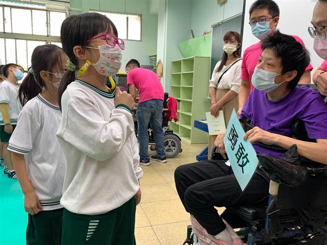 顶溪国小学生以个人特质自告奋勇上前线支援，右为关主脑性麻痹院生小纯。（社会局提供）