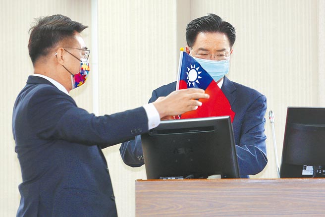 我驻德代表谢志伟日前在社群软体上发表「国旗告白文」引发热议。国民党立委江启臣（左）18日质询前，特别准备一面国旗送给外交部长吴钊燮（右），质问吴心中是否有国旗，并要求他现场挥舞。吴钊燮则回应自己心中当然有国旗，国庆等重要场合都有挥舞。（黄世麒摄）