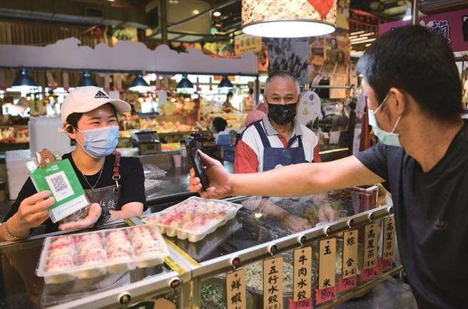 民眾于传统市场或夜市使用数位振兴券的行动支付消费。（图／经济部）
