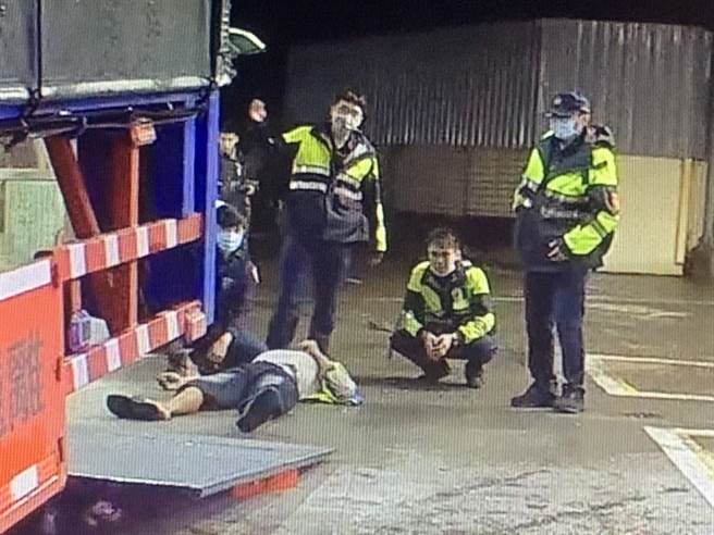 货车驾驶自修大货车，惨遭百公斤升降车尾门重压，所幸龟山警和路人齐心撑起救出，捡回一命。(翻摄照片／蔡依珍桃园传真)