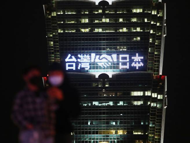 日本捐赠第6批约30万剂AZ疫苗27日运抵台湾，台北101于晚间6时30分起点灯打出「暖心互助」、「携手抗疫」等字样，感谢日本温暖深厚的友谊。（刘宗龙摄）