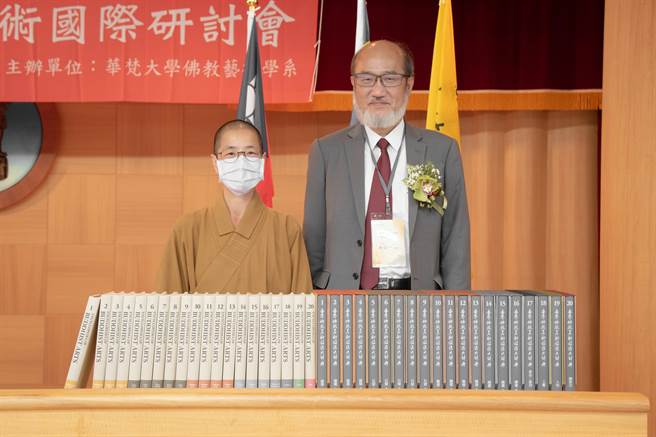 佛光山文教基金会副执行长妙殷法师（左）代表佛陀纪念馆捐赠《世界佛教美术图说大辞典》套书给华梵大学，由林从一校长代表受赠。（华梵大学提供）