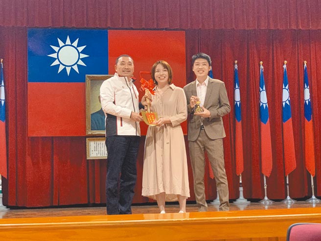 新北市长侯友宜9日表扬拦阻诈骗有功的银行专员刘纮君，并致赠他与未婚妻金铲子，祝新人早生贵子。（王扬杰摄）