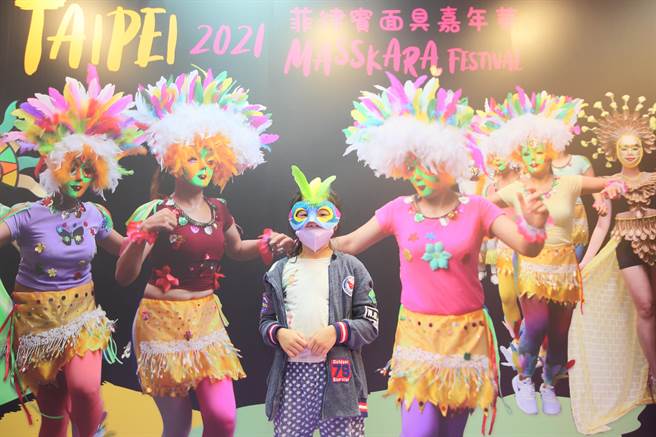 「菲律宾面具嘉年华」活动，今年从11月12日到28日在晴光市场、双城美食街举办。图为一位小朋友13日在晴光市场内的面具屋戴上自己DIY彩绘好的面具。（张铠乙摄）