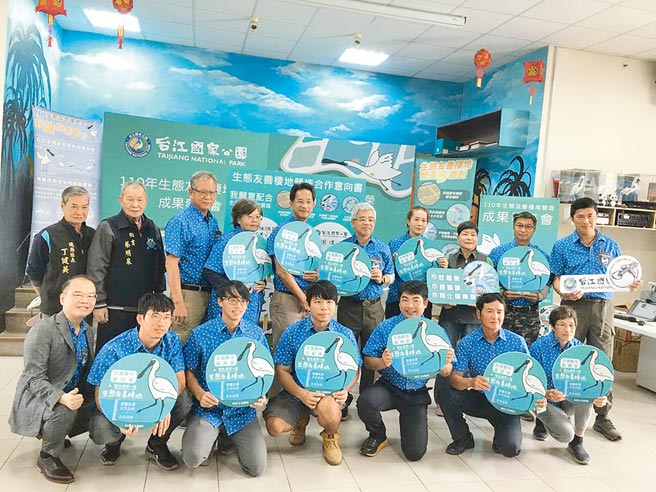 参加栖地生态保育的鱼塭主，手持告示牌合影。（台江国家公园提供／程炳璋台南传真）