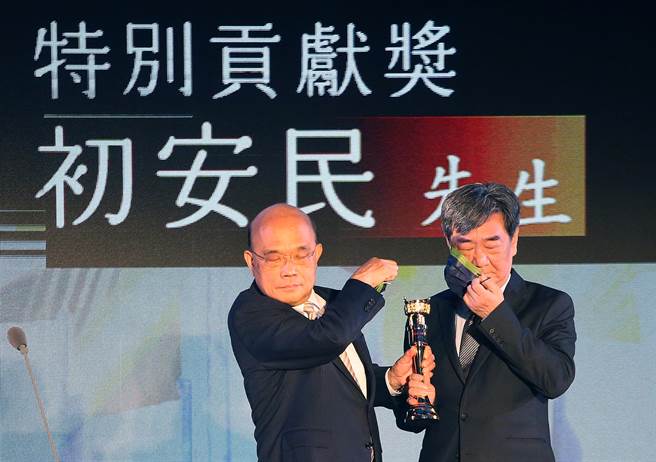 第45屆金鼎獎頒獎典禮17日舉行，行政院長蘇貞昌（左）將特別貢獻獎頒給印刻出版公司總編輯初安民（右），兩人合影前分別脫下口罩。（范揚光攝）