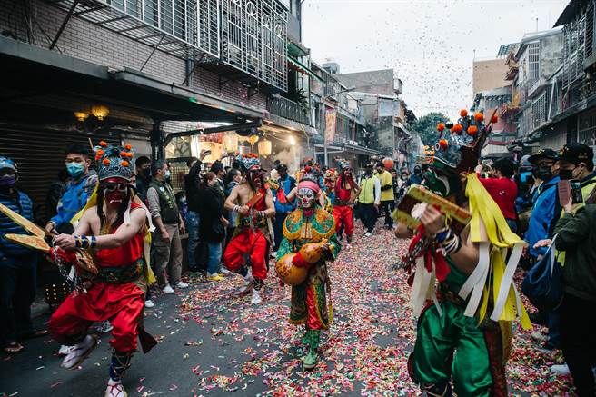 万华「艋舺青山王祭」登场，连续3天举行遶境、夜间暗访活动；青山宫八将由八人扮演，四人扮青面的锁将军，另四人为红面的枷将军，手持手铐、火籤、鲤鱼扣、虎头牌等刑具，站在红绿枷锁将军队伍中间的，则是由稚童装扮的引路童子，拿着收伏鬼魂的葫芦，相传为白鹤化身，指引前路。(郭吉铨摄)