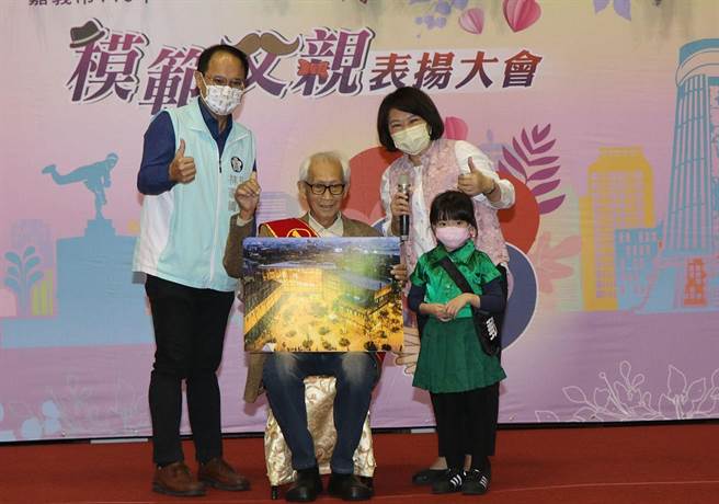 葉火炎（坐者）接受嘉義市長黃敏惠（後排右）表揚為模範父親 。（廖素慧攝）