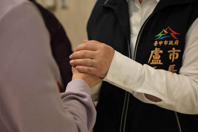「他是我們的同仁、也是我們的家人」，台中市盧秀燕緊握韓姓警員家屬，表達慰問之意。（台中市府提供／盧金足台中傳真）