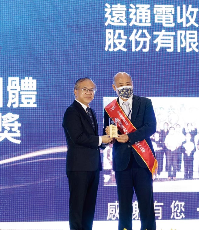 交通部政务次长陈彦伯（左）颁发「金安奖－企业团体贡献奖」殊荣，由远通电收总经理张永昌（右）代表接受。图／远通电收提供