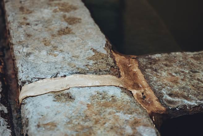 青磺泉的特性讓石砌浴池維持不易，每半個月就需補強石塊之間的縫隙。（攝影／張晋瑞）