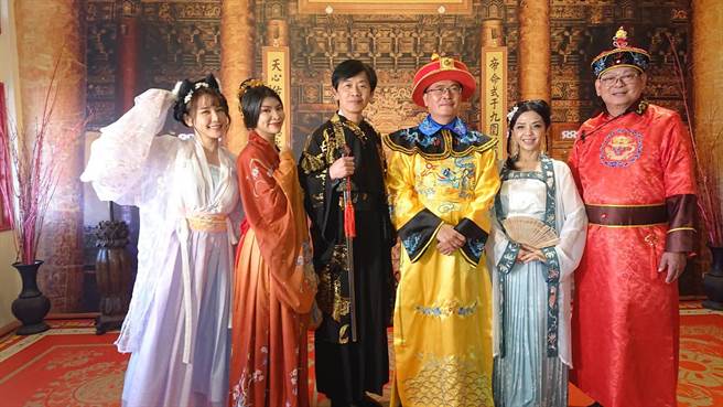 台南市文化局长叶泽山（中间黑衣者）穿起侠客古装，与穿起皇帝装的鹿耳门圣母庙主委王增荣，一起与打扮成古风的民眾合影。（程炳璋摄）