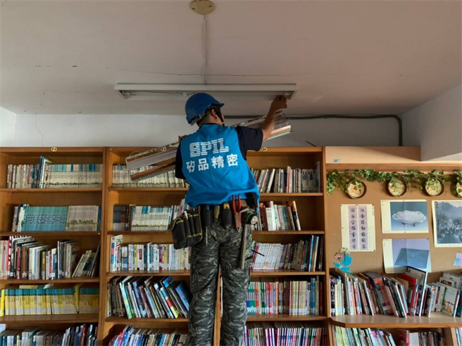 施工人員小心安裝LED燈具，並重新檢修電力線路。（矽品提供／王文吉台中傳真）