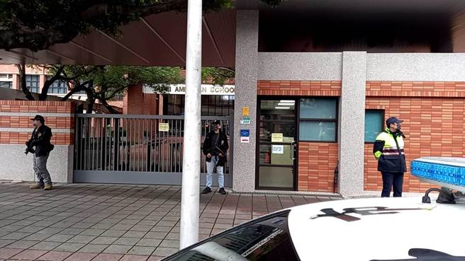 警方一早荷槍實彈在美國學校大門口站崗加強校園周邊維安工作。（圖／李文正翻攝）