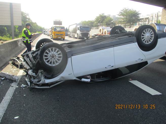 国道1号北向353.9公里处上午10时许发生车祸，一辆营业半联结车因变换车道不当，导致撞击另一部轿车，造成轿车（图）翻车。（翻摄照片／林瑞益高雄传真）
