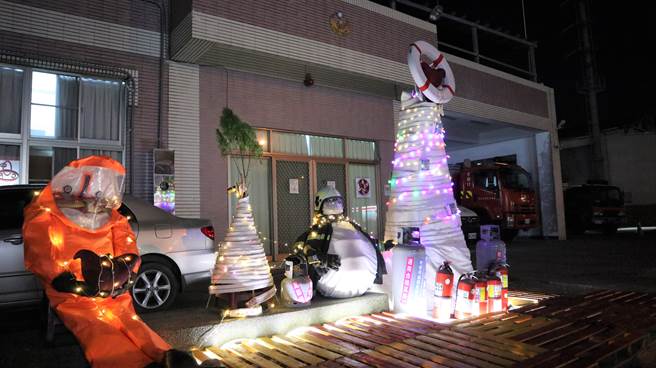 台南市政府消防局官田分隊在辦公廳舍門口前方，運用消防器材、廢棄物布置聖誕造景。（張毓翎攝）