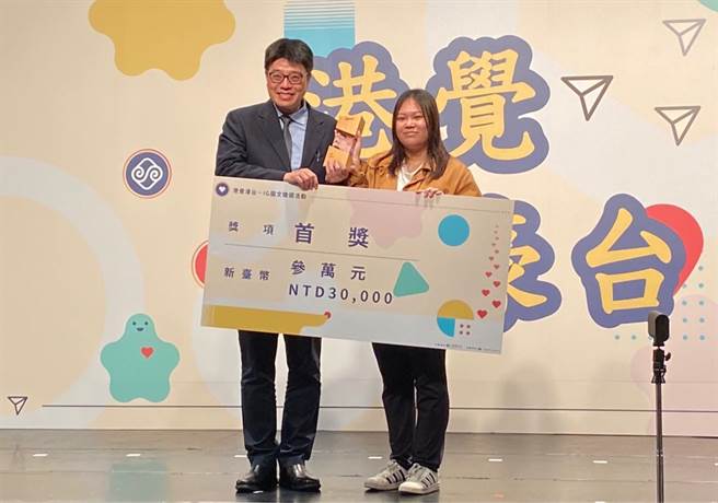 陆委会副主委邱垂正今在「港觉濠台IG图文徵选活动」颁奖典礼上，颁奖给首奖参赛者王晓霖拍摄的作品「抱抱鬼」。（林至柔摄）