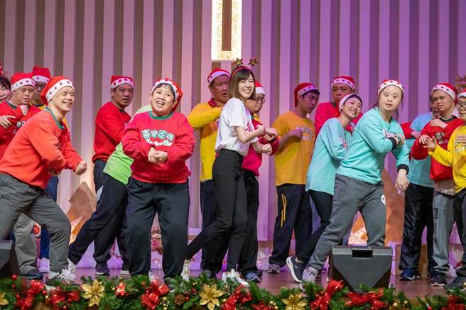 钱丽如（中）和身心障碍的孩子们边唱边跳欢庆耶诞节。（TVBS提供）