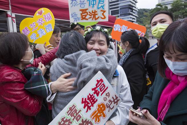 參加洗禮教友接受浸水禮前受到觀禮親友擁抱祝福。（黃子明攝）