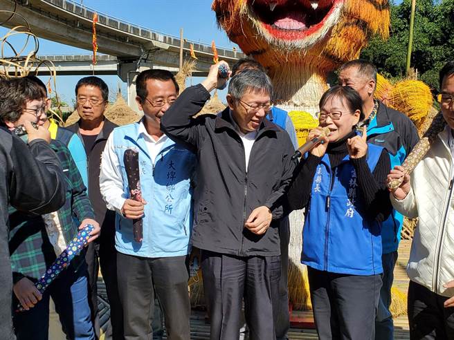 台北市长柯文哲今（2日）到云林县大埤乡参观稻草文化节，主办单位特地送他一支消除久站疲劳的捶打棒，他立刻拿起来试用搥背。（周丽兰摄）