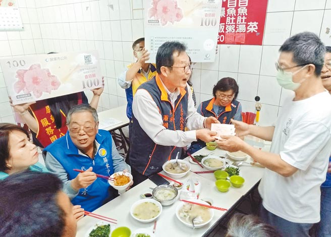 屏东市民代表会主席萧国亮（中）到夜市品尝小吃，用消费券刺激经济。（林和生摄）