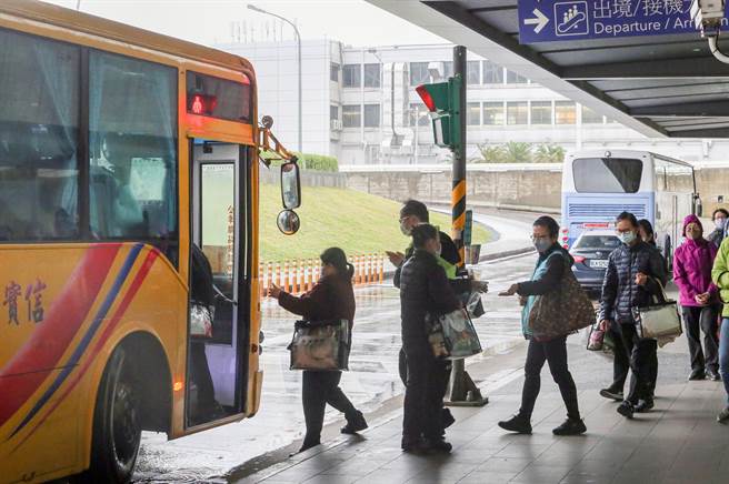 在桃机负责清洁工作的信实员工下班后搭乘公司交通车返家，上车前还有小组长在车门口帮同仁喷洒酒精消毒。（陈麒全摄）