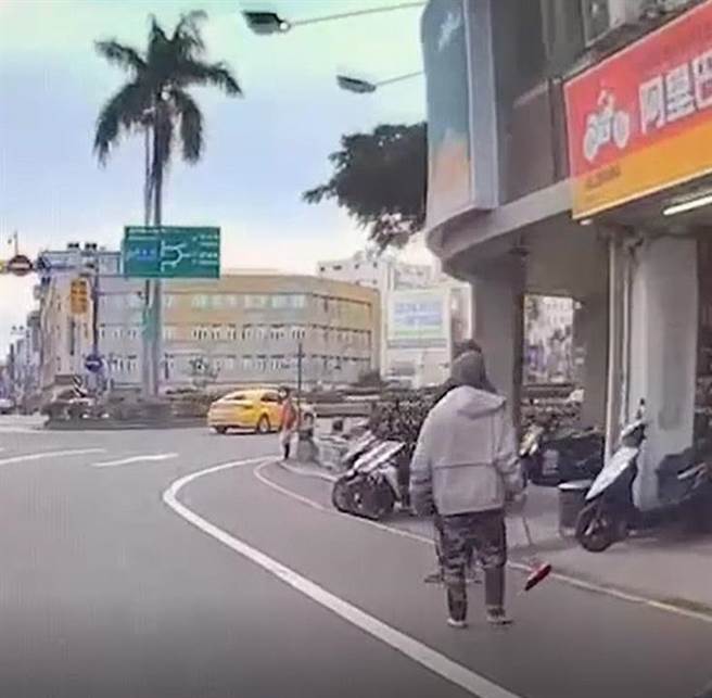 曾姓街友拿起掃帚欲追打林姓街友。（讀者提供／程炳璋台南傳真）