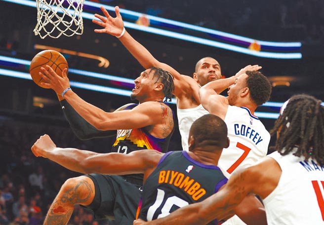 太陽前鋒威萊特（左）空中拉桿閃過快艇球員的巨掌封阻。（路透）