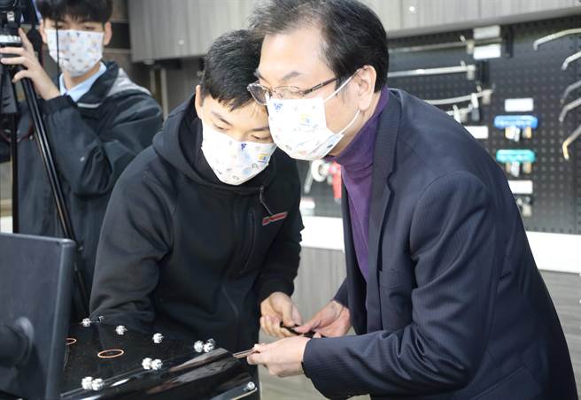 国手顏翔昱向刘和然介绍体验微板金教具版及工具。（新北市教育局提供）