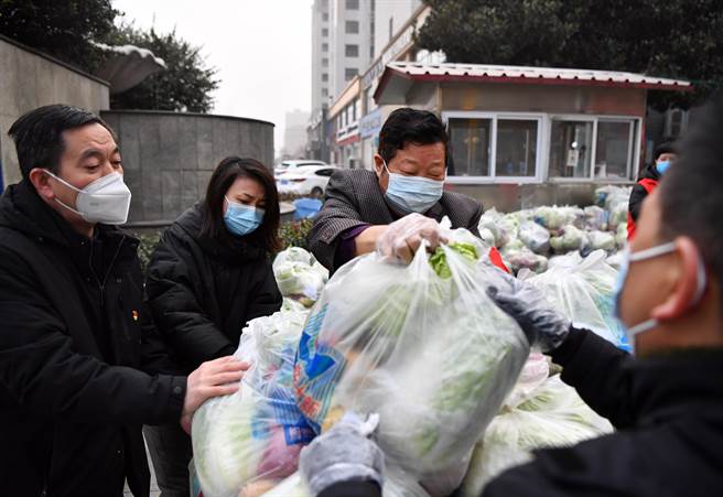 河南省《安阳日报》11日报导称，1月10日0时至11日8时，河南省安阳市新增本土确诊病例58例。图为禹州市永和苑社区，居民代表将蔬菜装车，准备发放给封控区的群眾。（新华社）