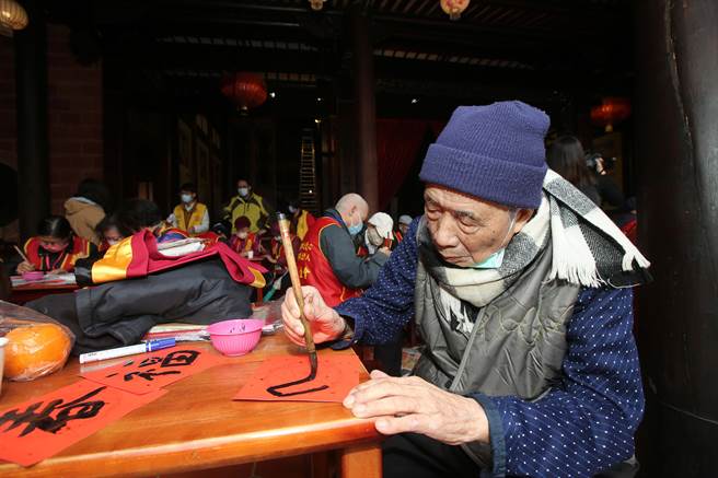 華山基金會12日在有百年歷史的霧峰林家宮保第園區舉辦「千歲揮毫」活動，100歲的耿爺爺也拿起毛筆寫春聯。（黃國峰攝）
