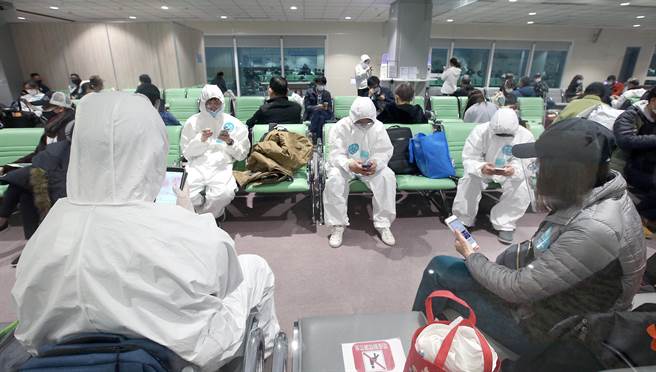在桃園機場入境管制區的候機室內，長程航班入境旅客採檢後等待檢測結果。（范揚光攝）