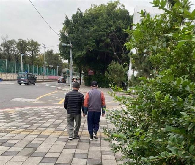 板橋2名老伯手牽著手一起散步逛街，引發網友熱烈討論、猜測2人關係。(圖／我是板橋人)