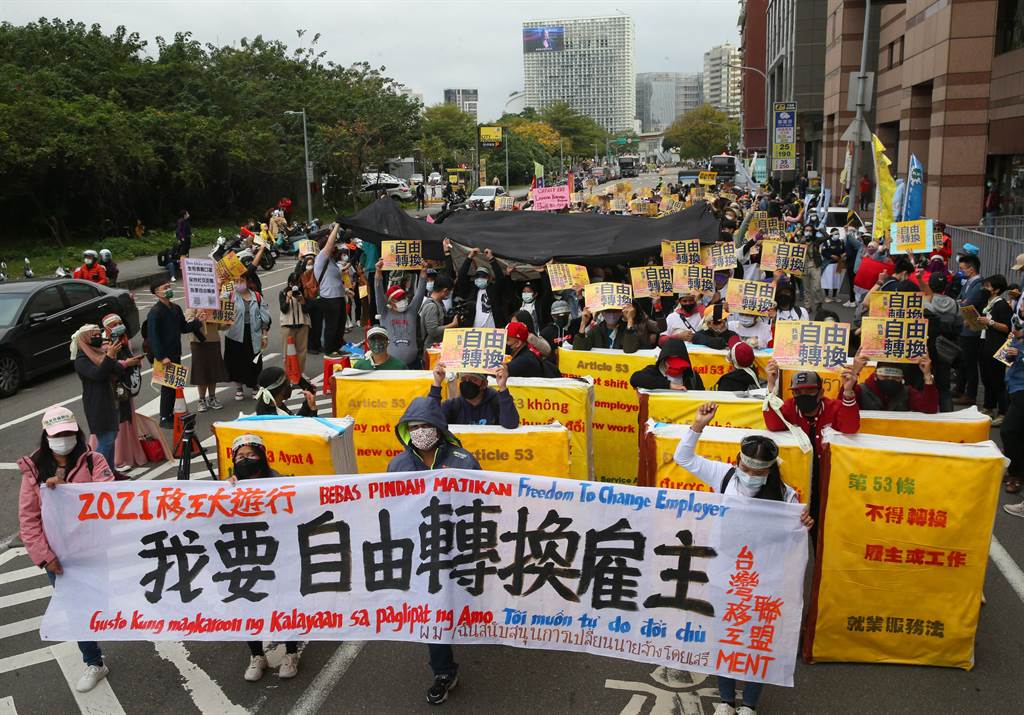 台灣移工聯盟「我要自由轉換」移工大遊行，參與移工遊行至民進黨中央大樓外，高舉標語表達想要自由轉換雇主的訴求。（陳君瑋攝）