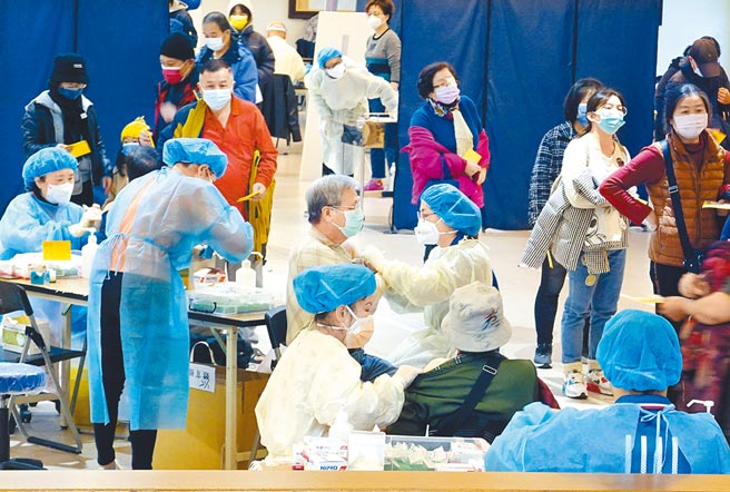 年关将至，为预防新冠肺炎疫情扩散，新北市政府设立中大型疫苗接种站，民眾15日陆续前往三重综合育馆，在医护人员分工合作下，井然有序的施打莫德纳疫苗。（姚志平摄）