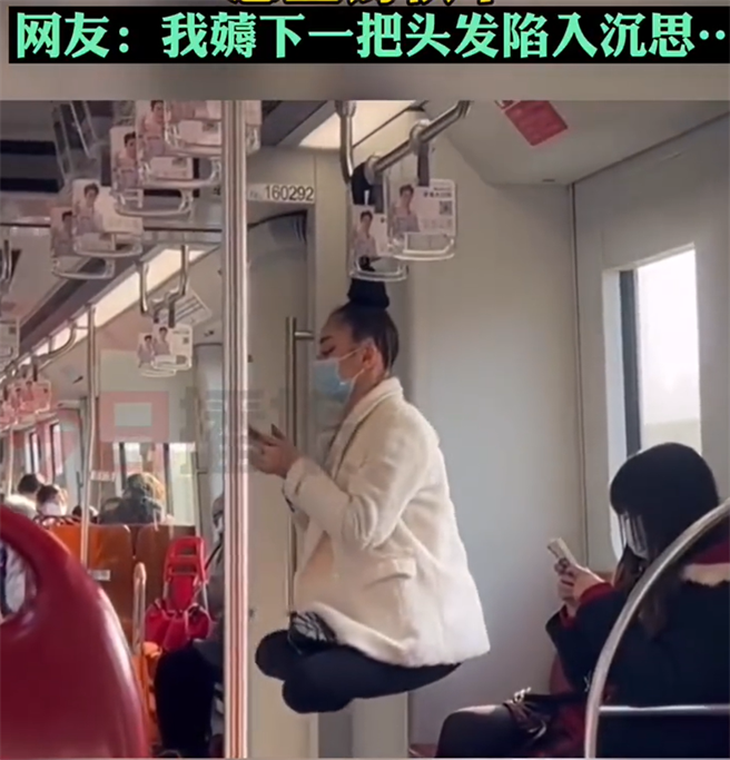 大陸上海地鐵出現「神燈女」凌空盤腿，竟將頭髮懸在把手盪鞦韆。(翻攝瀟湘晨報)