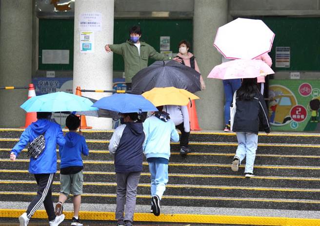 台北市石牌国中日前传出有学生家人确诊，校方21日表示，20日下午收到通知后，已随即清消，该学生同班同学、授课老师约48人已完成PCR检验，所有人皆为阴性，21日早上扩大採检同楼层班级师生共326人，图为该年级学生返校准备筛检。（张铠乙摄）
