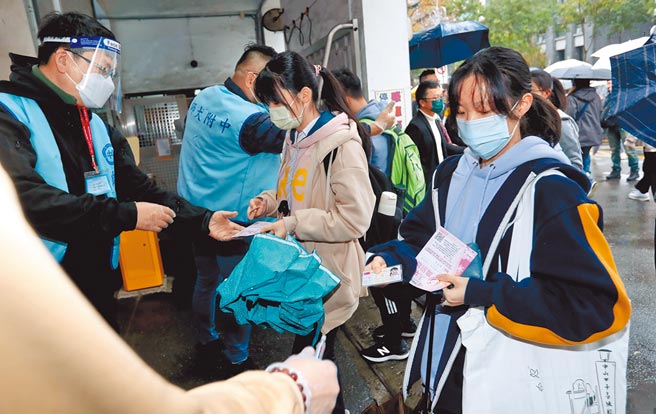111年大学学测21日登场，北市师大附中考场入口的考生除了配合量体温、戴口罩，也必须查验身分证件后才能入场考试。（郑任南摄）