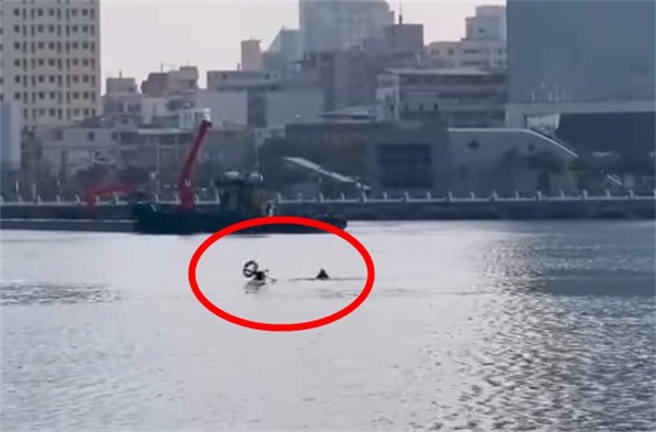 无人机载着救生圈搭救溺水者，没想到却当场「坠入水中」消失水面，让溺水者赶紧上前抢救，附近民眾与媒体纷纷看傻眼。（翻摄自脸书「记者爆料网」）