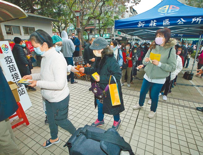 春节期间本土疫情持续，新北市政府5日在新庄四维活动中心提供2000剂莫德纳疫苗让民眾接种，民眾排队等候。（陈怡诚摄）