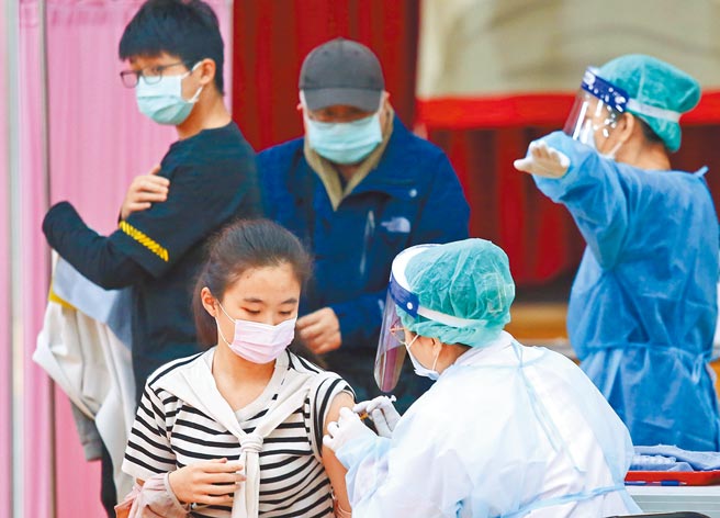 北市2月7日至9日加開12至18歲青少年BNT疫苗第1、2劑，及北市國小、幼兒園、特教學校及社教機關專案造冊教職員工BNT追加劑特別門診專案接種。圖為昨日懷生國中施打站接種情形。（陳俊吉攝）