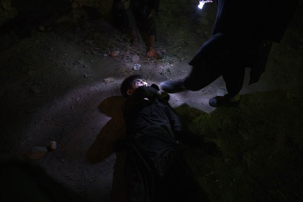 塔利班矢言消灭毒瘾，在街头抓有毒瘾的流浪汉进医院勒戒。图为1名睡着的人遭塔利班踹醒逮捕。(图/美联社)(photo:ChinaTimes)